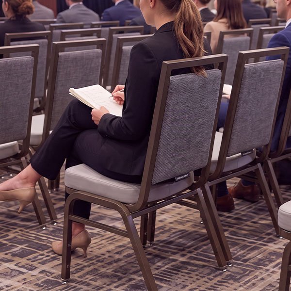 Commercial hospitality chair supporting guests in a conference and meeting environment.