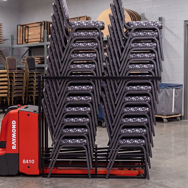 Platform Chair Dolly transporting up to 48 stacking banquet chairs in a hospitality storage area
